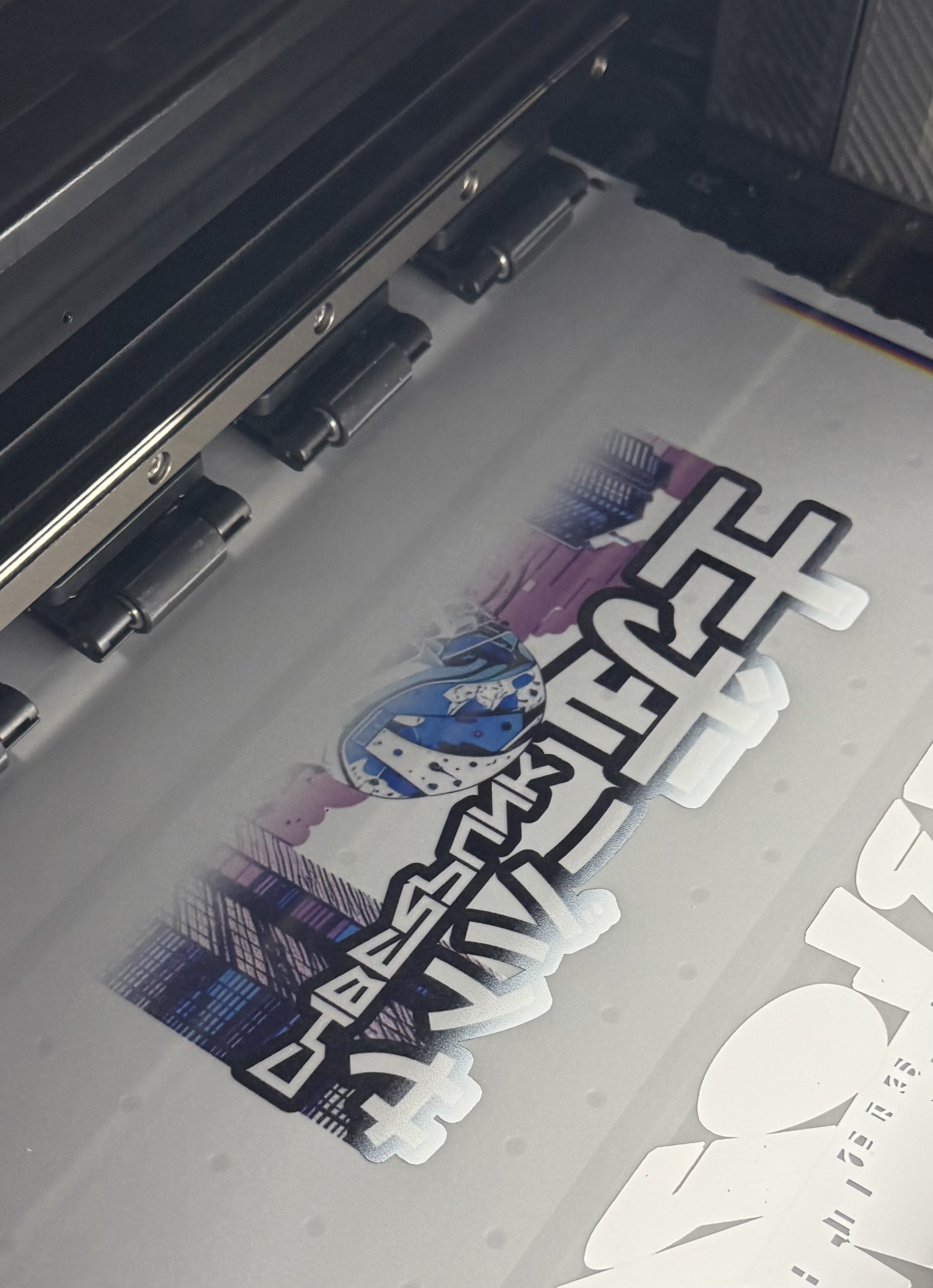 DTF prints rolling off the machine press